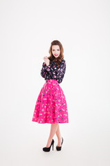 Charming happy young woman in bright pink skirt
