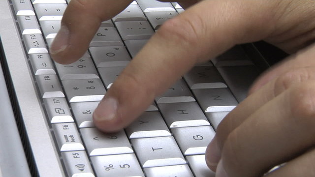 Fingers typing on keyboard