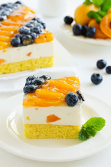 Sponge cake with yogurt mousse, apricots and blueberries.