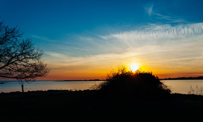 Fototapeta na wymiar Valborgsmässoafton; en siluett av en otänd brasa i solnedgången