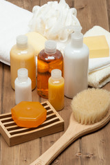 Obraz na płótnie Canvas Spa Kit. Shampoo, Soap Bar And Liquid. Shower Gel. Towels. Woode