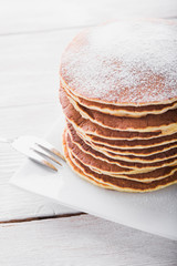 stack of pancakes with powdered sugar