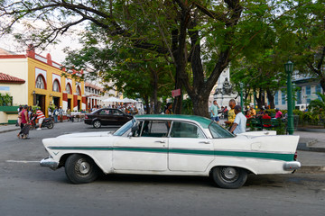 People driving a vintage car at Santiago de Cuba, Cuba