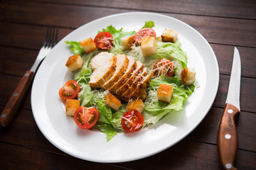 Caesar salad with chicken and tomato