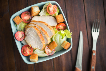 Caesar salad with chicken and tomato
