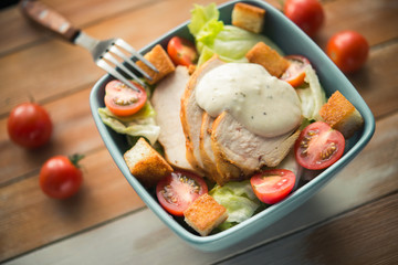 Caesar salad with chicken and tomato