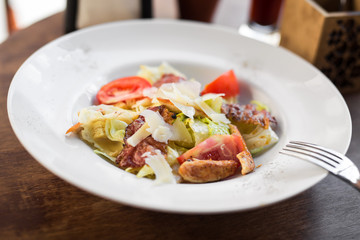 Caesar salad with chicken and tomato