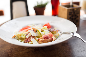 Caesar salad with chicken and tomato