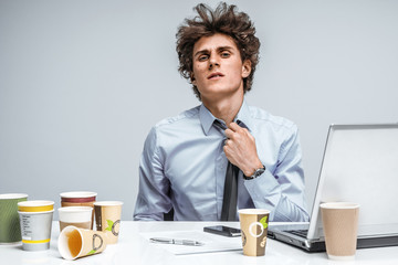 Tired student. Overwhelmed man turned away from the laptop screen. Education concept
