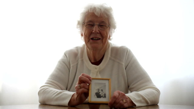 Portrait of senior woman holding a picture