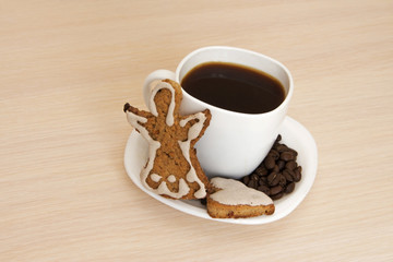 Cup of coffee with cookies on a wooden background