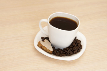 Cup of coffee with cookies on a wooden background