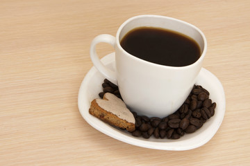 Cup of coffee with cookies on a wooden background