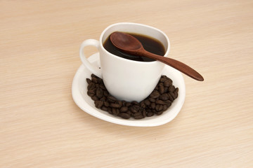 Cup of coffee on a table with a wooden spoon