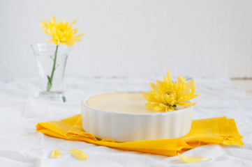 Obraz na płótnie Canvas Portion cheesecake on white and yellow background