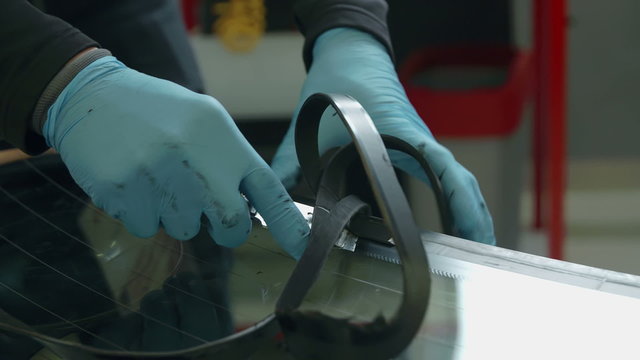 Taking old rubber off the back window on a car