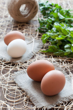 Chicken eggs, bunch of parsley and twine