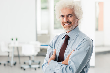 Confident businessman posing in the office