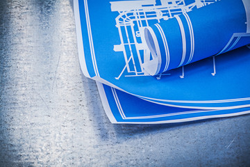 Blue blueprints on scratched metallic background