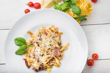 pasta with bacon on white plate background