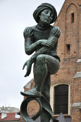 Obraz premium Bronze statue of a poor student near St Mary's Basilica located in Krakow, Poland