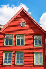 Red wooden house against the blue sky