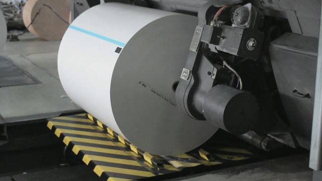 Big paper rolls being prepared for the production of leaflets