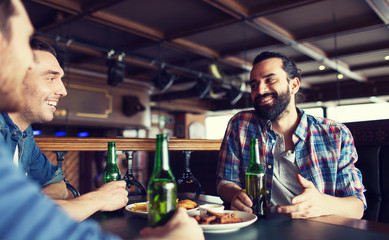 happy male friends drinking beer at bar or pub