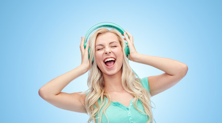 happy young woman or teenage girl with headphones