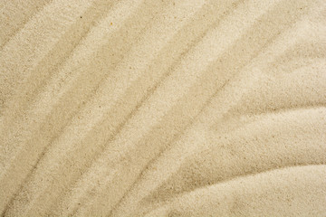 Fototapeta na wymiar closeup of sand pattern on a beach in the summer