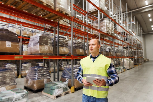 manual worker with tablet pc at warehouse