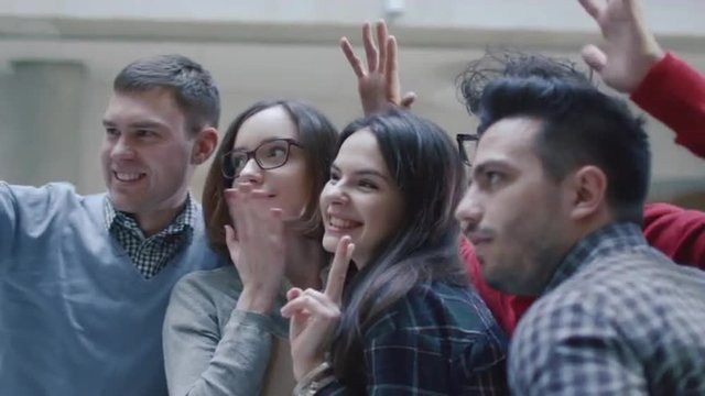 Group of young multi-ethnic students are making selfie pictures in a college. Shot on RED Cinema Camera.
