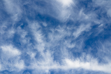 Cloudscape over horizon. Blue sky and white clouds.