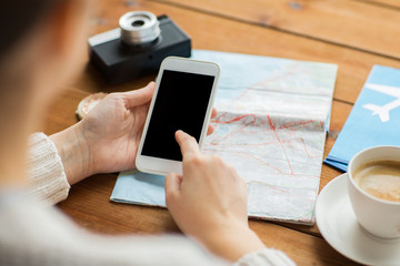 close up of traveler hands with smartphone and map