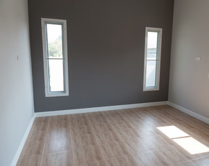 room with window and gray wall
