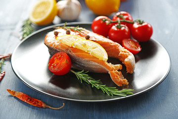 Fish with vegetables on plate