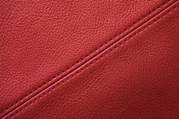 Red leather background with sewing seam - obrazy, fototapety, plakaty