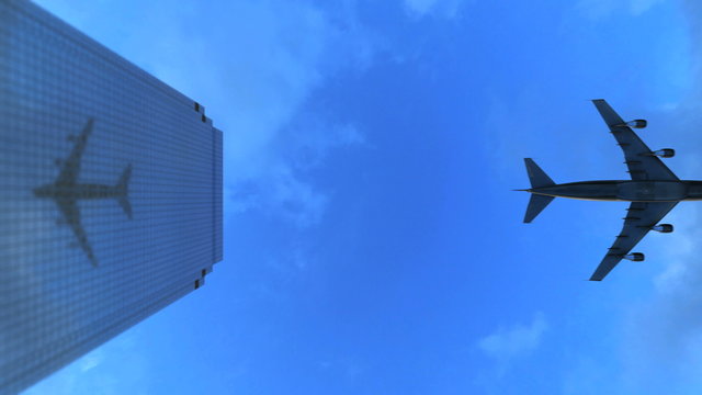 Video 4096x2304 4K - Down-top view of the airplane flies over the top of a skyscraper and reflects in its glass surface