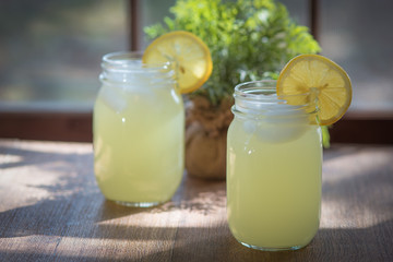 Jars of lemonade in front of a sunny window