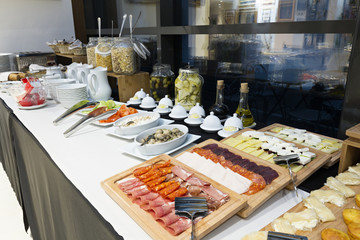Hotel breakfast served on buffet table 