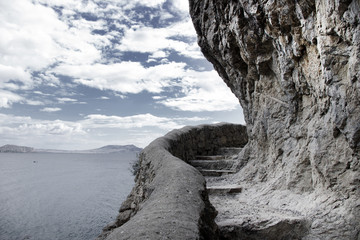 The path for tourists on a rock by the sea