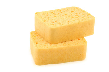 yellow household sponges on a white background