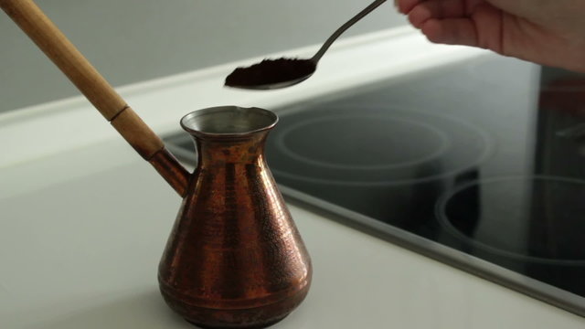 Graund coffe filling up to copper turk.
