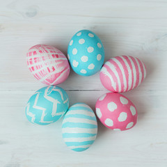 Fototapeta na wymiar Pink and blue easter eggs on a wooden background