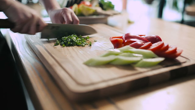 Cook chopped green onions on a cutting board