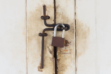  door with lock in metal material and copyspace on wall.