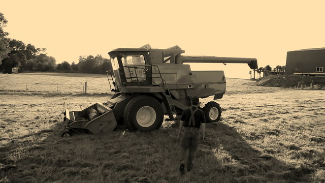 Farmer walks out to combine