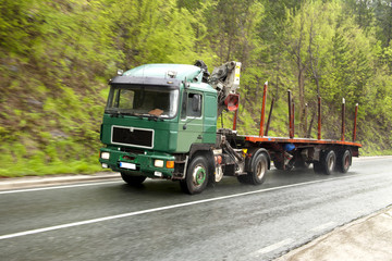 Fototapeta na wymiar Green Truck On The Road