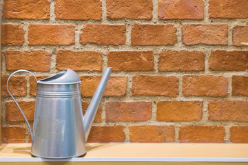 Brick wall , watering pot