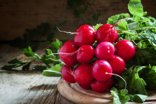 bunch of red radishes on a cutting board, selective focus